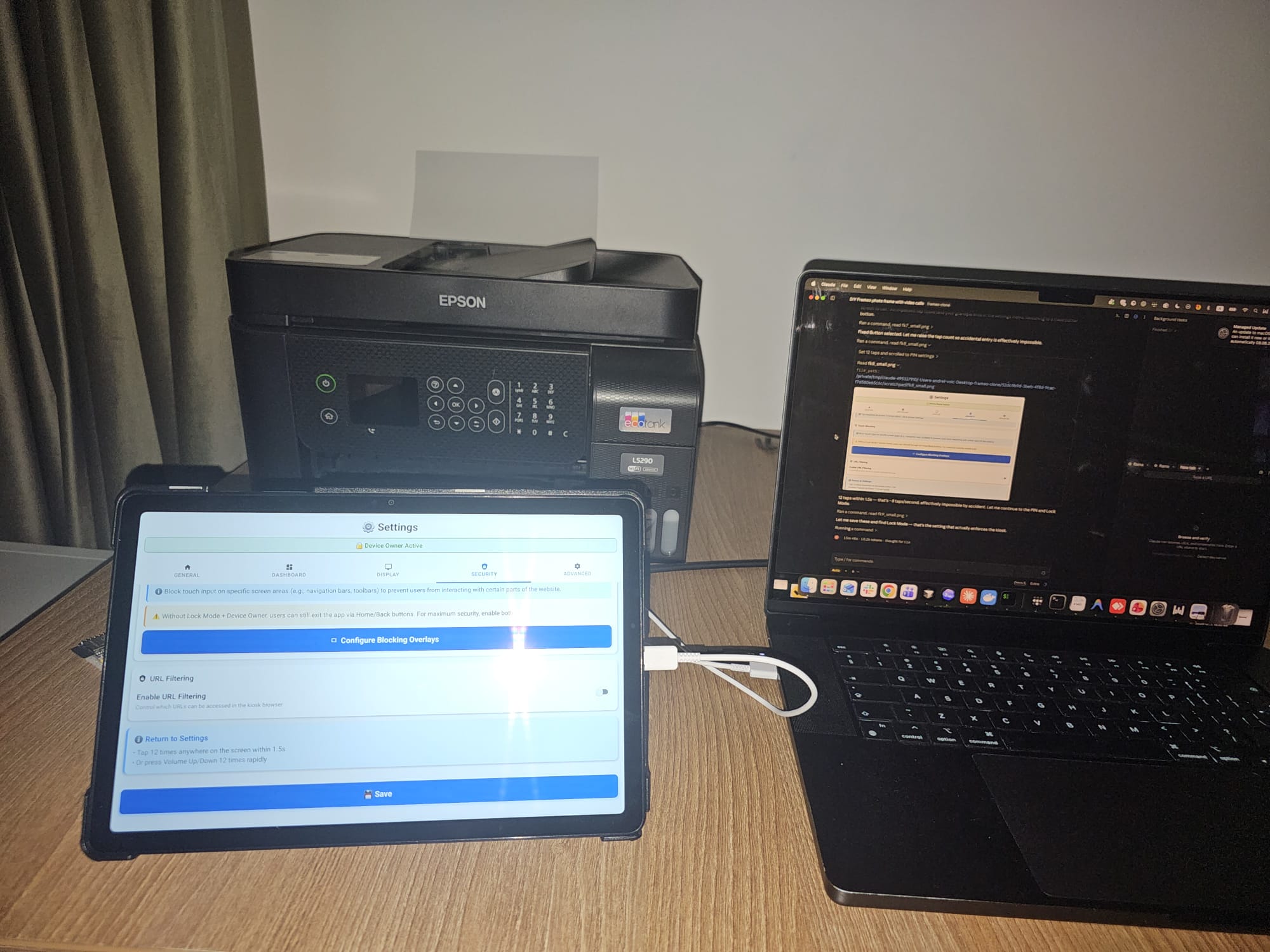 A tablet connected by USB to a laptop running Claude Code, being turned into a photo frame
